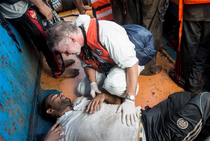 A critical patient suffering from suspected fuel inhalation lies in the hull of a wooden boat in August 2015. He was stabilised aboard the MY Phoenix, run by Médecins Sans Frontières/Doctors Without Borders (MSF) and another NGO, MOAS. He was ultimately medevac'ed via helicopter for further treatment on land. * PHOTO - GABRIELE FRANÇOIS CASINI/MSF