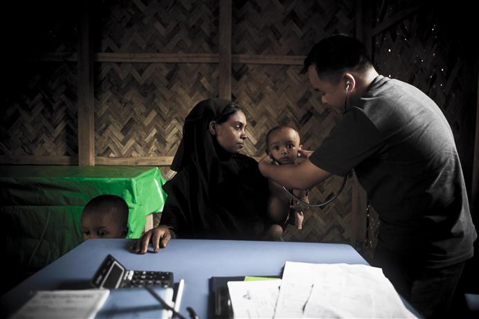 A young child receives a checkup at the Médecins Sans Frontières/Doctors Without Borders (MSF) clinic in Kutupalong in August 2009, the year MSF began running its current primary healthcare project providing medical care to the community in and around Ukhia and to Rohingya people fleeing Myanmar. * PHOTO - CRISTINA DE MIDDEL