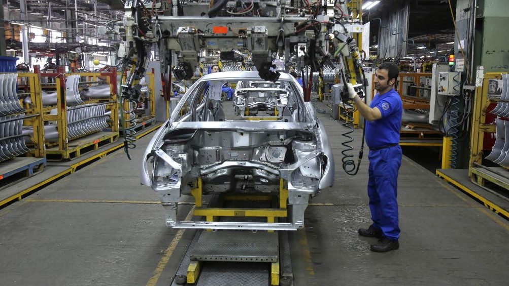 An Iranian worker assembles a car at the Iran Khodro automobile manufacturing plant