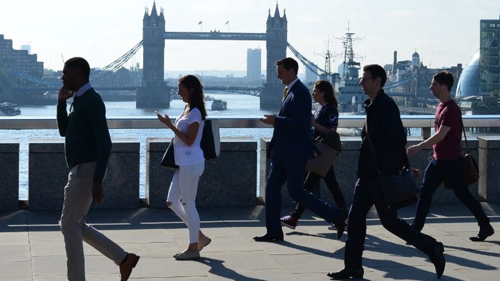 Commuters heading into the City of London cross London Bridge in front of Tower Bridge on Jun 24, 2016