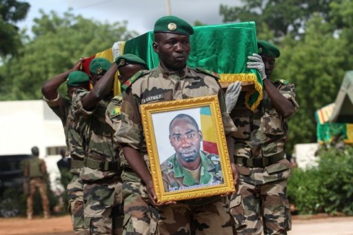 Malian army officers carry the coffin of a soldier killed during an attack on a military base in Nampala claimed by the Ansar Dine jihadist group