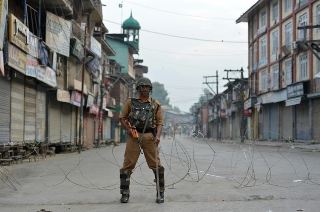 An Indian paramilitary troop stands guard during a curfew in Srinagar on July 10, 2016