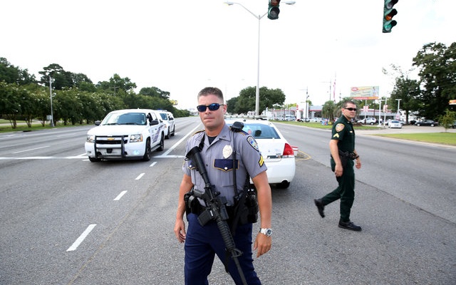 Police officers block off a road after a shooting of police in Baton Rouge, Louisiana