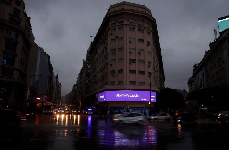 An advertising electronic board reads "Lio Messi don't go" in Buenos Aires