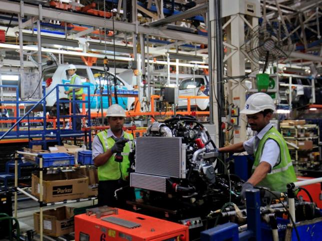 Employees work inside the General Motors plant in Talegaon