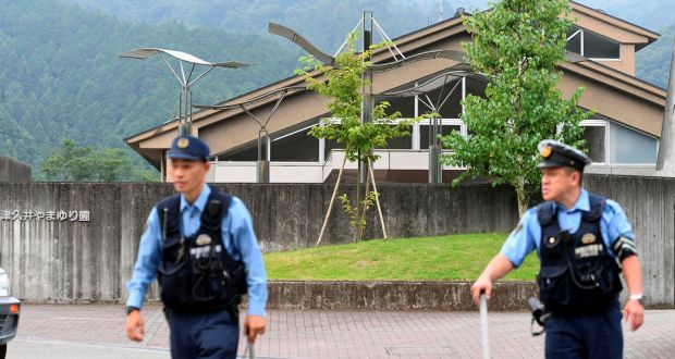 Police officers in front of a facility for the disabled where at least 19 people killed in knife attack