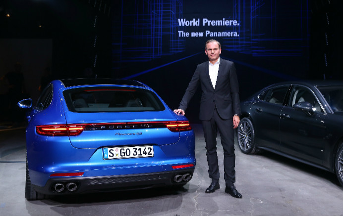 Oliver Blume, Chairman of the Executive Board of Porsche AG standing beside the new Porsche Panamera