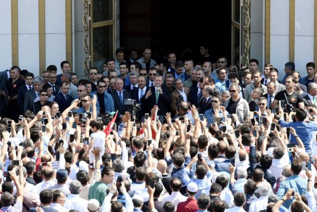 Turkish President Tayyip Erdogan addresses his supporters after the Friday prayers in Ankara, Turkey