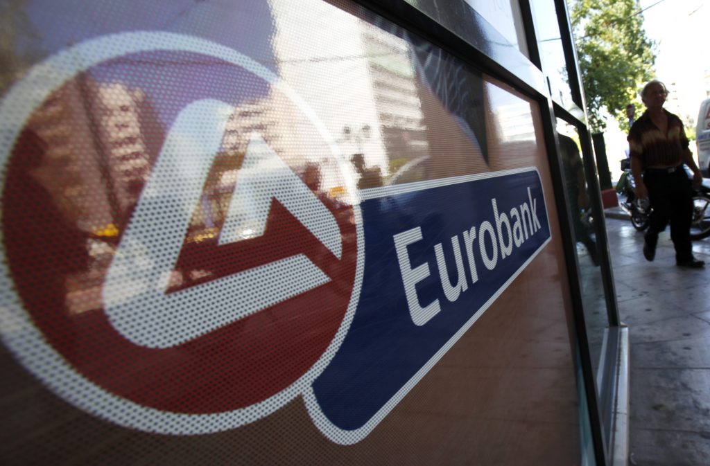 An EFG Eurobank Ergasias SA company logo sits outside a branch in Athens, Greece, on Tuesday, Aug. 24, 2010. Greek banks are under growing political pressure to merge as second-quarter earnings probably slumped on rising loan losses and worsening asset quality in the debt-burdened country. Photographer: Kostas Tsironis/Bloomberg