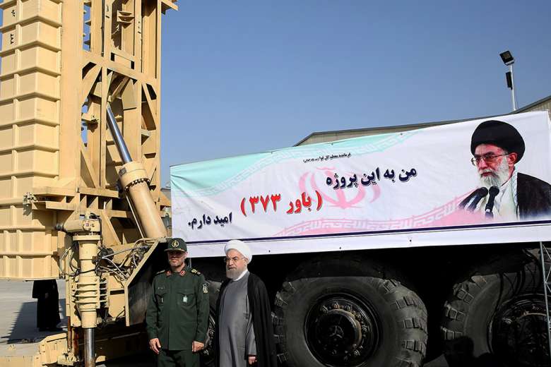 Iranian President Hassan Rouhani (centre) and Iranian Defence Minister Hossein Dehghan (left) standing next to the new Bavar 373 missile defence system in Teheran