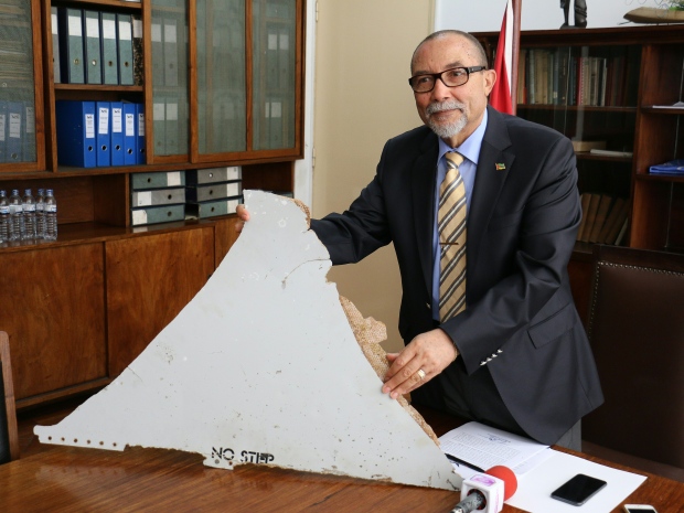 Joao de Abreu, president of Mozambique's Civil Aviation Institute, holds a piece of suspected aircraft wreckage 