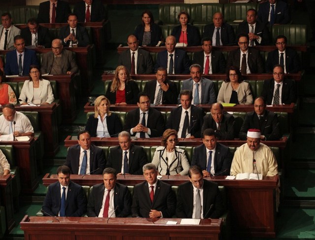 (Front row from L-R) Tunisia's Interior Minister Hedi Majdoud, Defence Minister Farhat Horchani, Justice Minister, Ghazi Jribi and premier-designate Youssef Chahed, (2nd row from L-R) Foreign Minister Khemaies Jhinaoui, Minister of Religious Affairs Abdeljalil Ben Salem, Minister of Finance Lamia Zribi and Minister to the Head of State for Parliament Relations Iyad Dahmani attend a parliamentary session to present his Chahed's governement at the parliament in Tunis on August 26, 2016.  It is likely that a majority of parliament's 217 members will vote for the line-up, making Chahed, at 40, the country's youngest prime minister since it won independence from France in 1956.  / AFP PHOTO / STRINGER