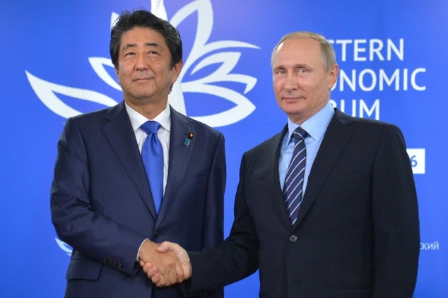Russian President Vladimir Putin (right) shakes hands with Japanese Prime Minister Shinzo Abe during a meeting on the sidelines of the Eastern Economic Forum in Vladivostok on September 2, 2016