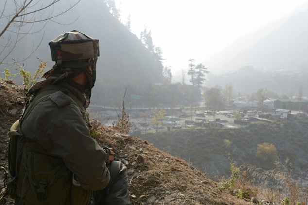 An Indian soldier keeps watch over the army barracks Gingal Uri, Kashmir