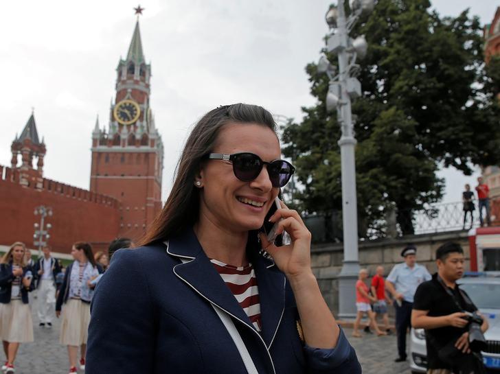 Russian track-and-field athlete Yelena Isinbayeva talks on her mobile phone as she walks at Red Square in Moscow, Russia 