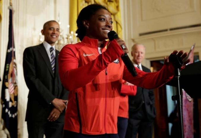 2016 Olympic individual all-around gymnast Simone Arianne Biles speaks between U.S. President Barack Obama and Vice President Joe Biden