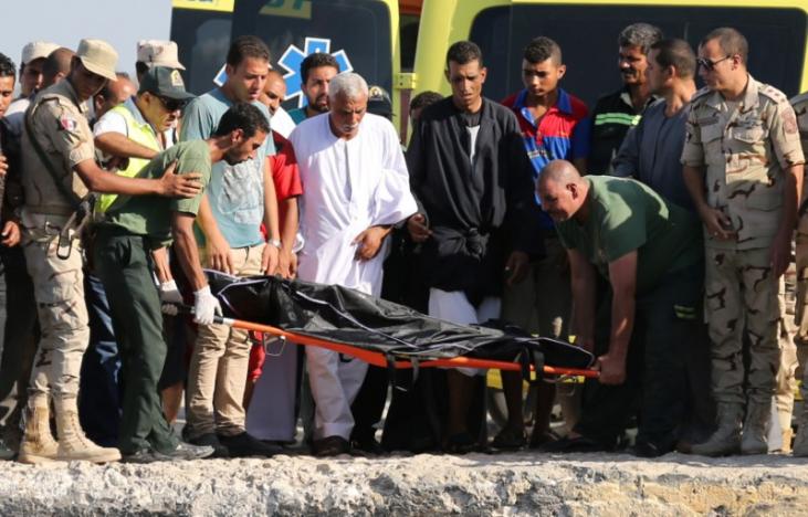 Rescue workers carry the body of a victim on a stretcher after a boat carrying migrants capsized off Egypt's coast, in Al-Beheira, Egypt