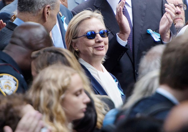 Hillary Clinton listens during a memorial service at the National 9/11 Memorial