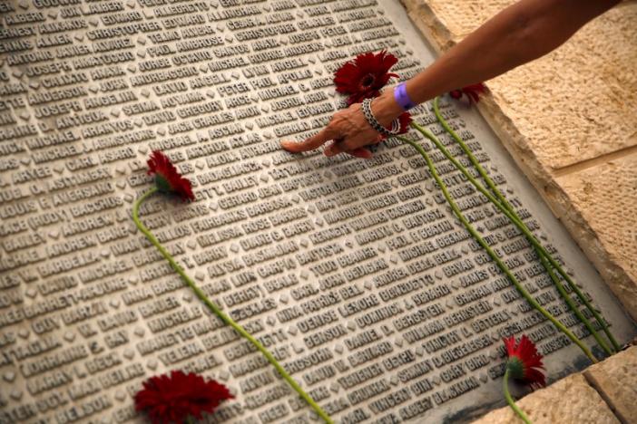 A family member of an Israeli victim of the September 11th attacks, points to the victim's name, engraved on a monument, during a memorial event marking the 15th anniversary of September 11, 2001 attacks in the U.S., at the 9/11 Living Memorial Plaza in Jerusalem 