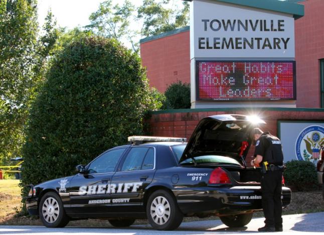 An Anderson County sheriff's deputy stands outside of Townville Elementary School after a shooting in Townville, South Carolina, U.S., September 28, 2016. REUTERS/Nathan Gray