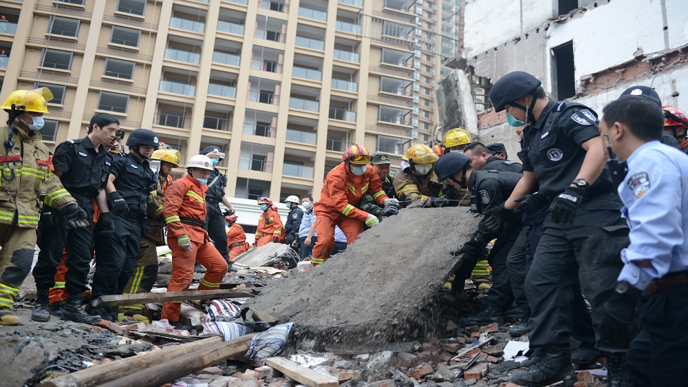 Rescue workers search at the site where residential buildings collapsed in Wenzhou, Zhejiang province, China