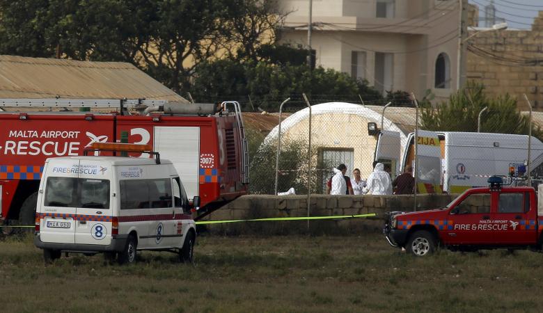 Investigators and rescue services at the scene of a plane crash at the airport in Valletta, Malta