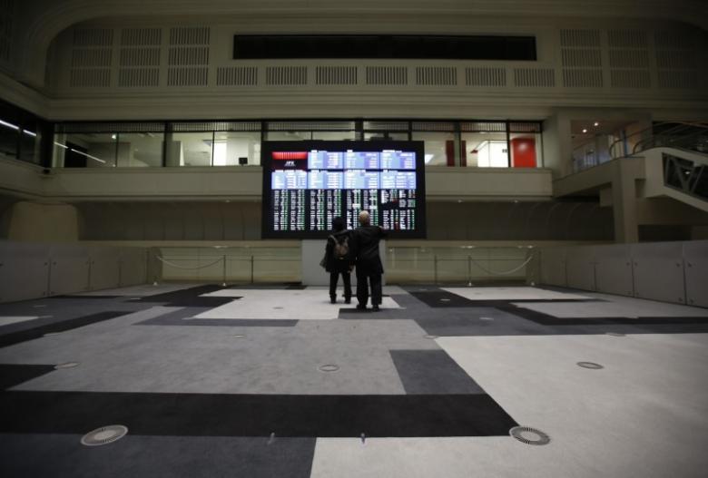 Visitors looks at an electronic board showing the Japan's Nikkei average at the Tokyo Stock Exchange (TSE) in Tokyo, Japan