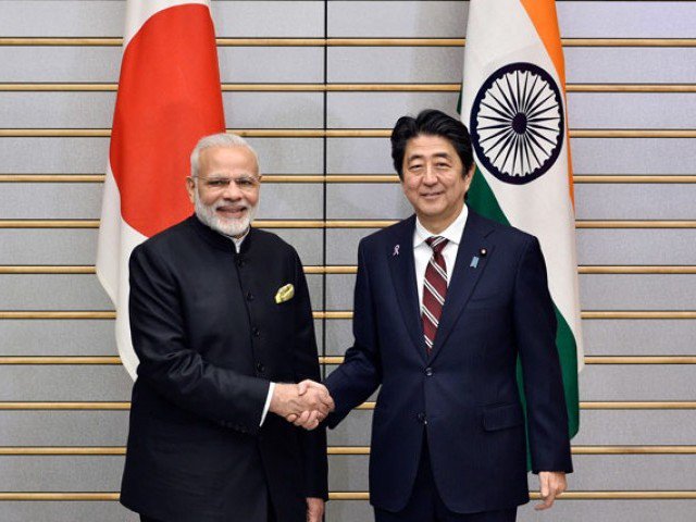 ndia's Prime Minister Narendra Modi (L) shakes hands with his Japanese counterpart Shinzo Abe at the start of their meeting at Abe's official residence in Tokyo on November 11, 2016