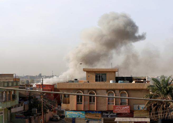 Smoke rises from an area controlled by the Islamic State after a member of the Iraqi Counter Terrorism Service fires mortars during a fight with Islamic State militants in the al-Zahraa neighborhood of Mosul, Iraq