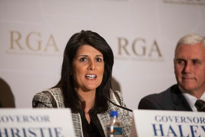 Governor Nikki Haley (R-SC) answers a question next to Governor Mike Pence (R-IN)  (R) during a news briefing at the 2013 Republican Governors Association conference in Scottsdale, Arizona