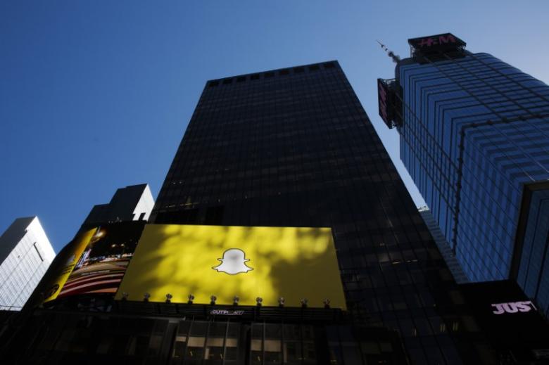 A billboard displays the logo of Snapchat above Times Square in New York