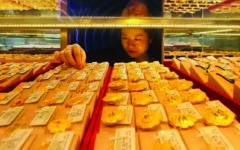 Dollar sinks on yen intervention talk, gold breaks $5,000